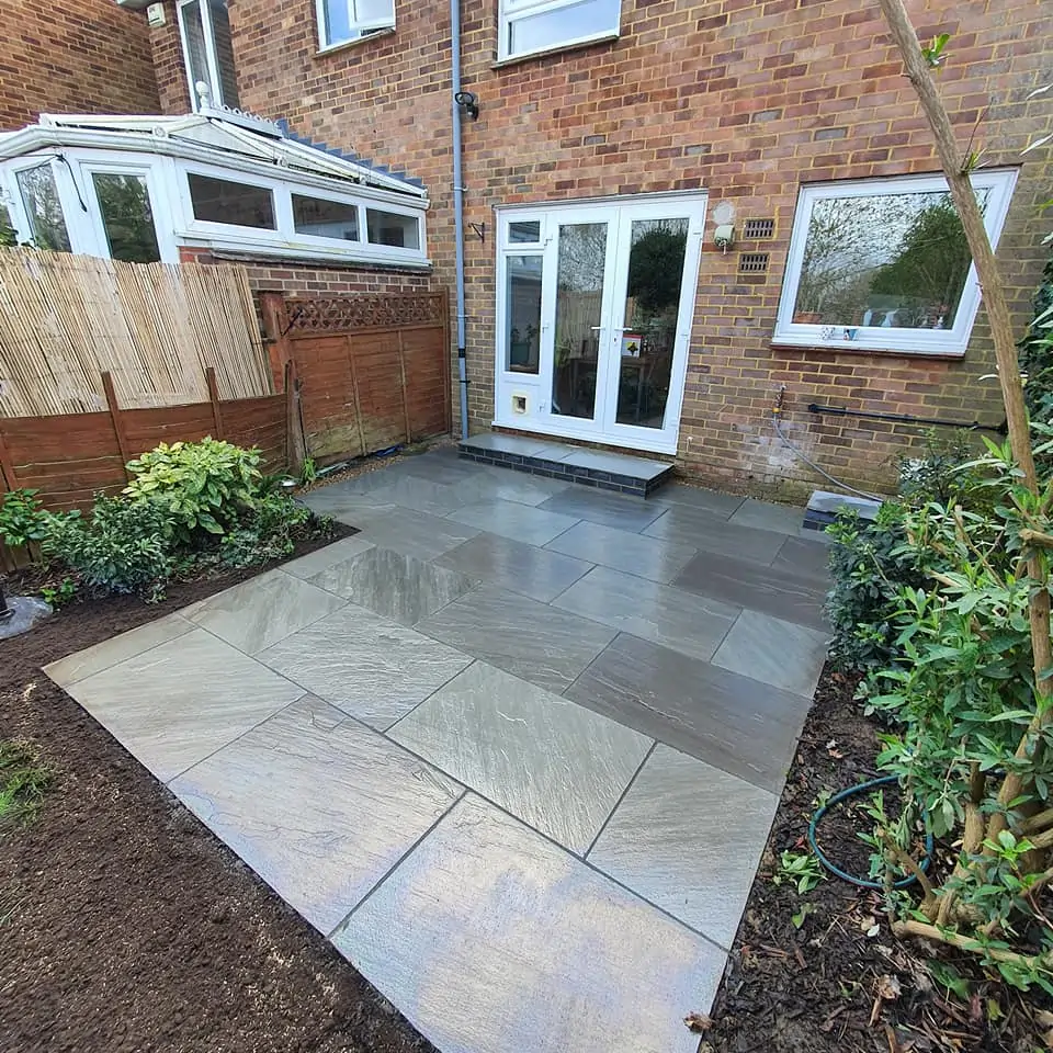 Natural stone patio design in Woking completed by Prestige Garden Maintenance for a stylish and functional garden area.